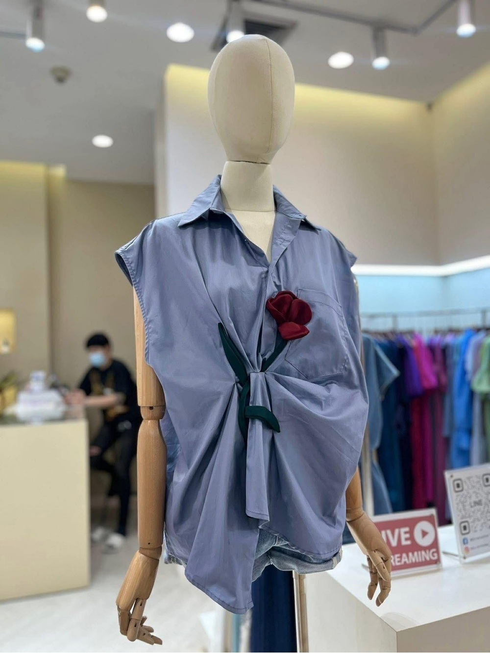 Sleeveless Twist-Front Shirt with Rose Accent - Light Blue